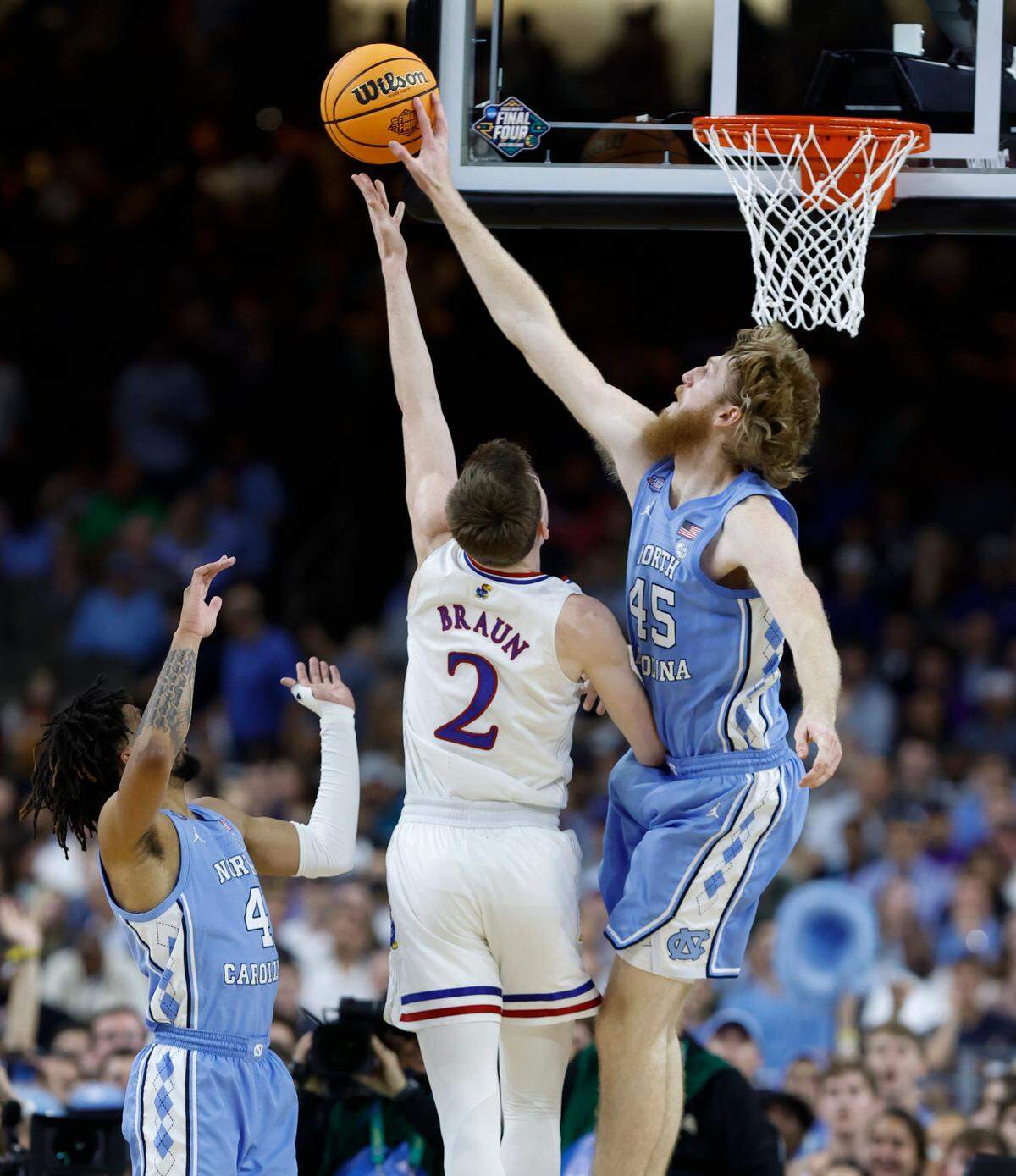 North Carolina’s Brady Manek (45) blocks the shot by Kansas’ Christian Braun (2) during the first half of UNCís game against Kansas in the NCAA Menís National Championship at the Caesars Superdome in New Orleans, La., Monday, April 4, 2022.