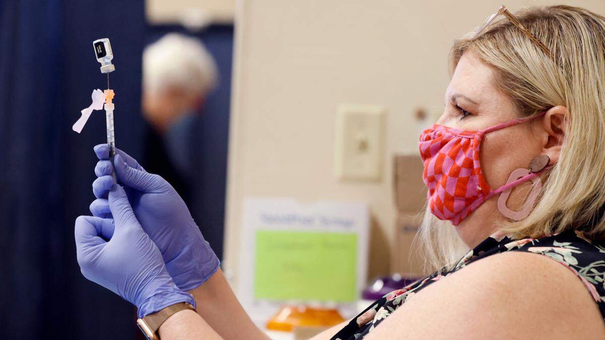 WakeMed pharmacist Michelle Cook prepares a Pfizer Covid-19 vaccine during the WakeMed Back-to-School Blitz vaccine clinic at the WakeMed Raleigh Campus in Raleigh, N.C., Sunday, August 1, 2021.