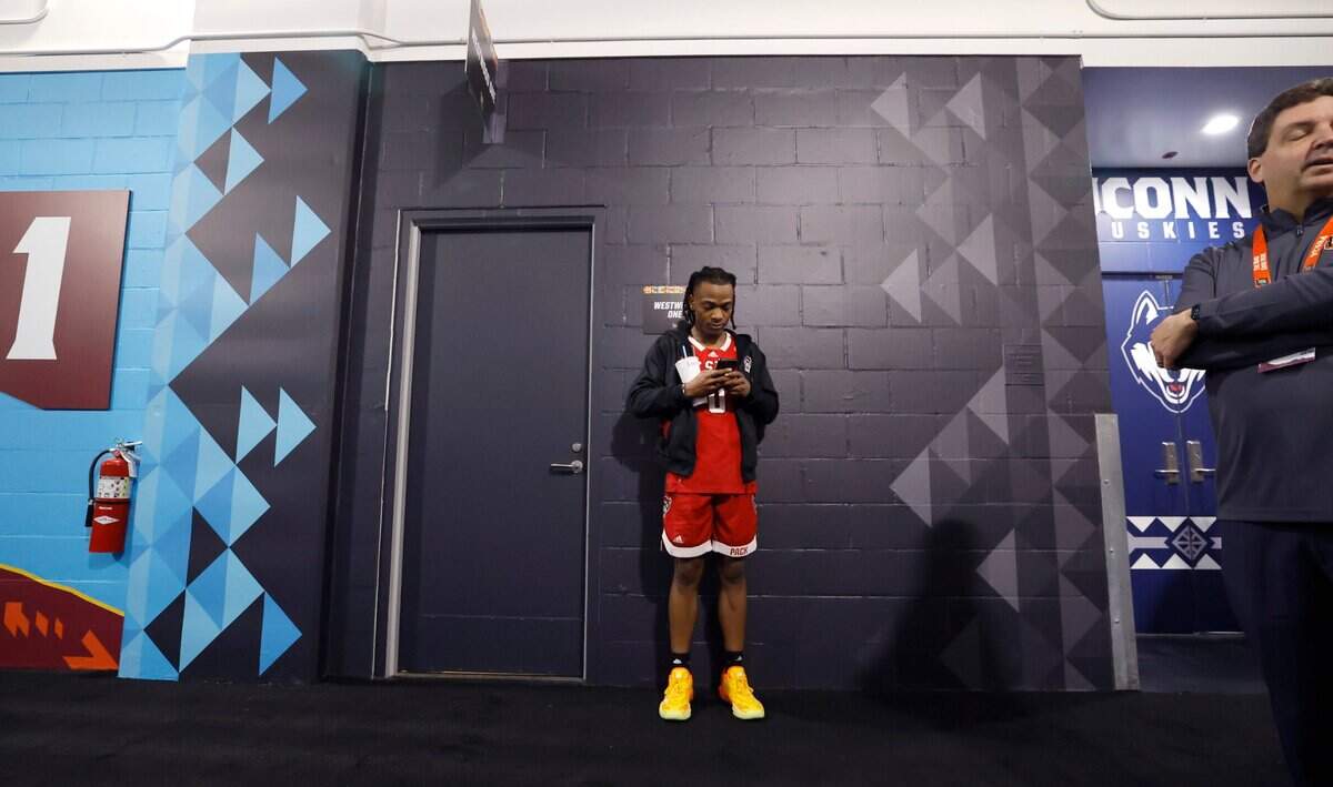 N.C. State’s DJ Horne waits to be interviewed by Westwood One at State Farm Stadium in Glendale, Ariz. Thursday, April 4, 2024. The Wolfpack will face Purdue in the Final Four on Saturday.