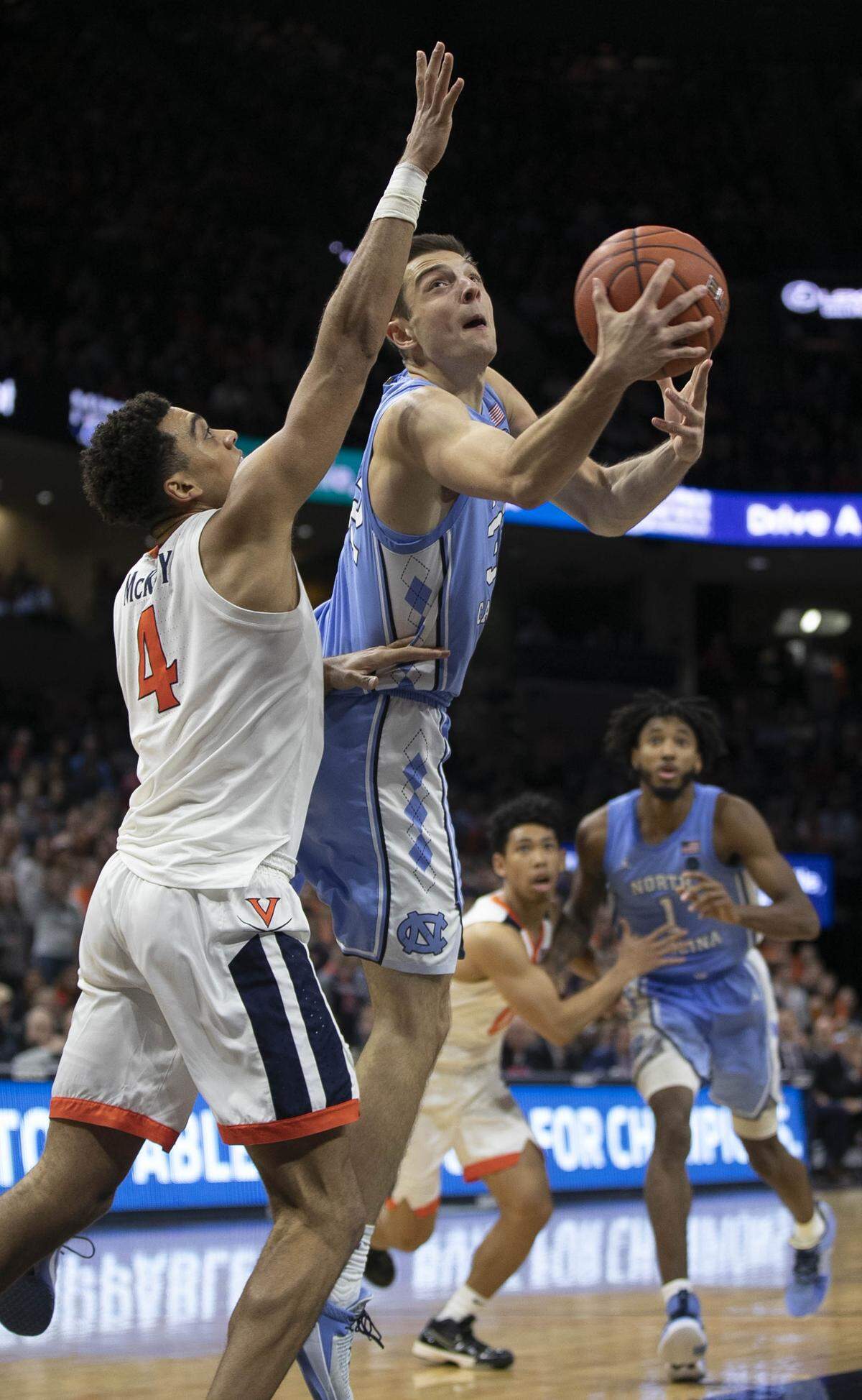 North Carolina’s Justin Pierce (32) drives to the basket against Virginia’s Justin McKoy (4) during the second half on Sunday, December 8, 2019 at John Paul Jones Arena in Charlottesville, Va.