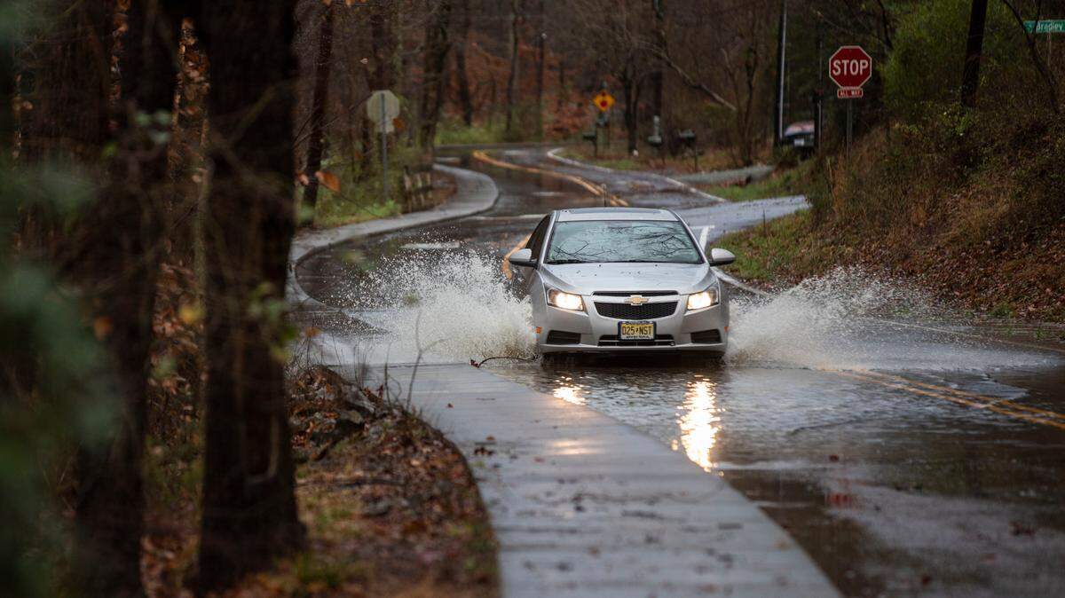 A car drives through high water on Umstead Drive along Bolin Creek in Chapel Hill, N.C. on Monday morning, Jan. 3, 2022.