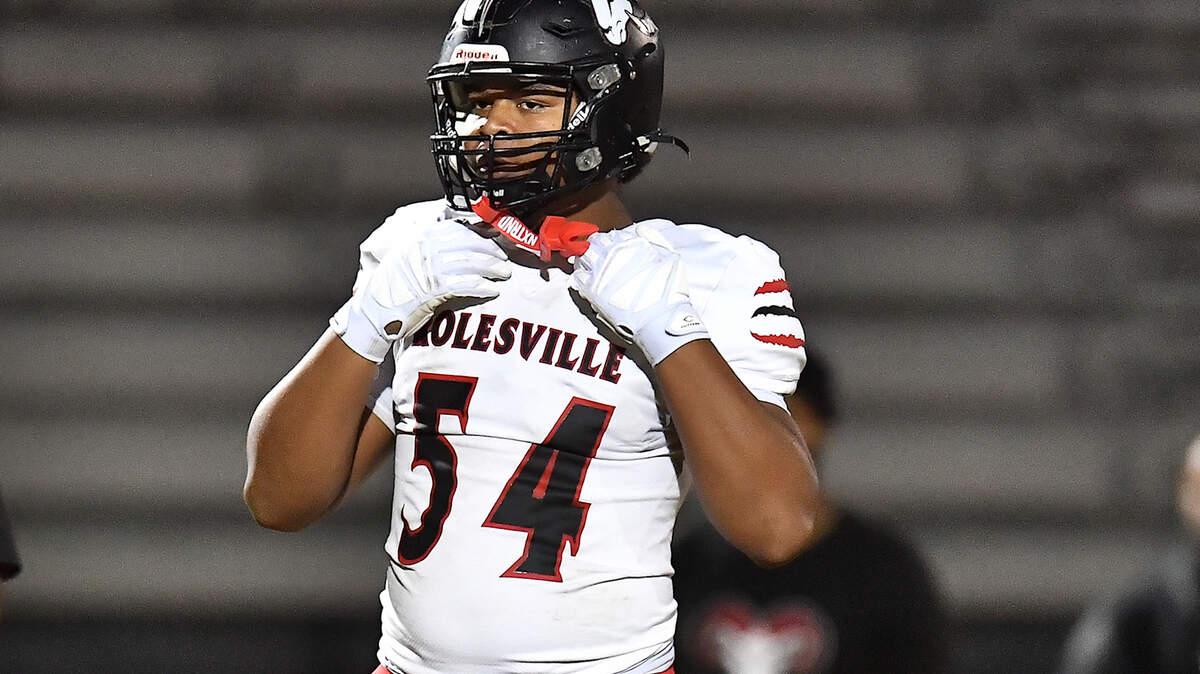 Rolesville defensive lineman Malachi Harris (54) looks to the sidelines during pregame drills before their playoff matchup against Apex Friendship. The Apex Friendship Patriots and the Rolesville Rams met in the second round of the NCHSAA 8A Playoff game in Apex, N.C. on November 14, 2025. Rolesville wins 14-7 in overtime.