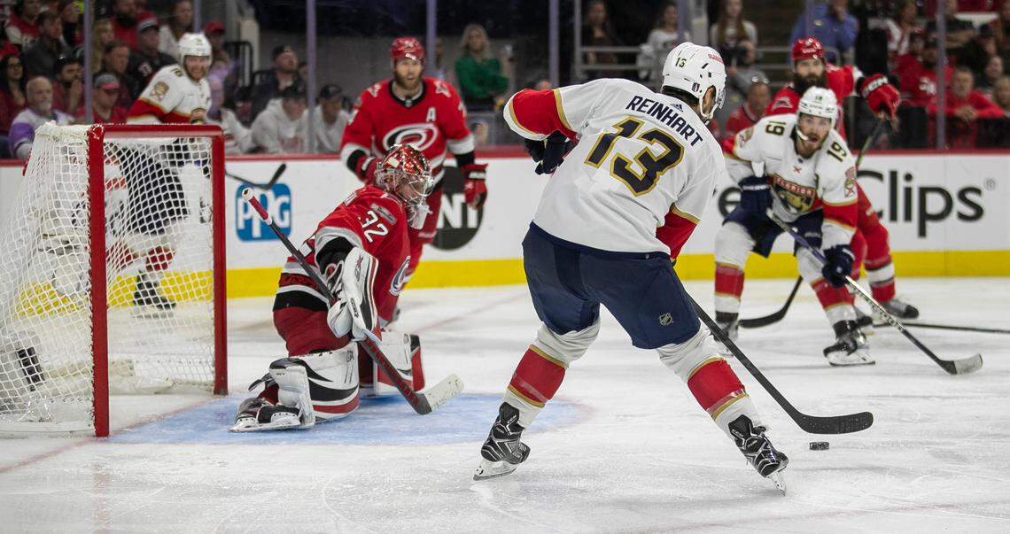 The Florida Panthers Sam Reinhart (13) passes to an open Matthew Tkachuk (19) for the game winning goal in overtime to secure a 2-1 victory over the Carolina Hurricanes in Game 2 of the Eastern Conference Finals on Saturday, May 20, 2023 at PNC Arena in Raleigh, N.C. The Hurricanes Jaccob Slavin (74) and Brent Burns (8) were tangled up on the play and were unable to defend Tkachuk.