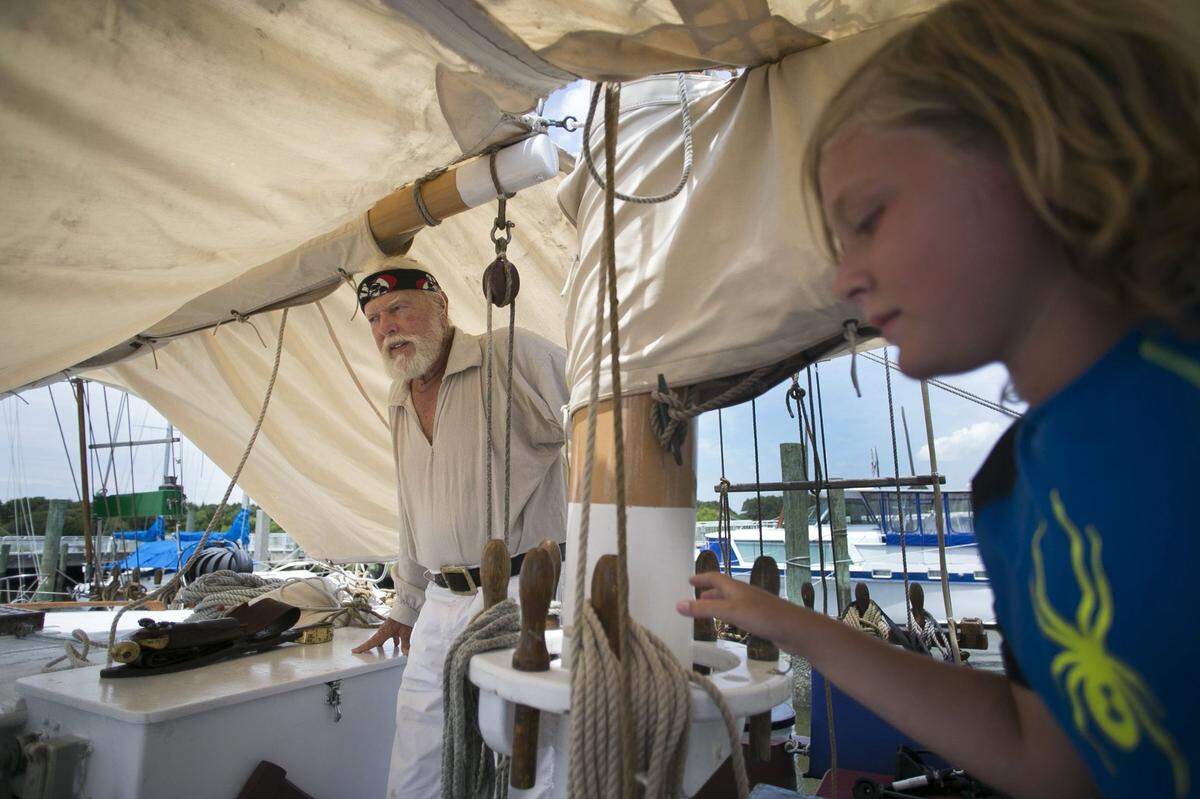 Captain Horatio Sinbad and his grandson Christian Torkington set up a canvas cover aboard Sinbad’s Meka II on Monday, June 25, 2018 in Beaufort, N.C.