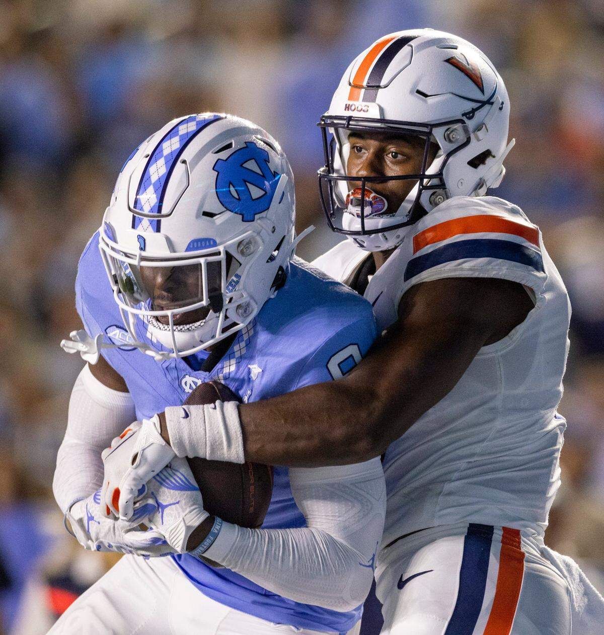 North Carolina’s Armani Chatman (9) intercepts a pass intended for Virginia’s Malachi Fields (8) in the second quarter on Saturday, October 21, 2023 at Kenan Stadium in Chapel Hill, N.C