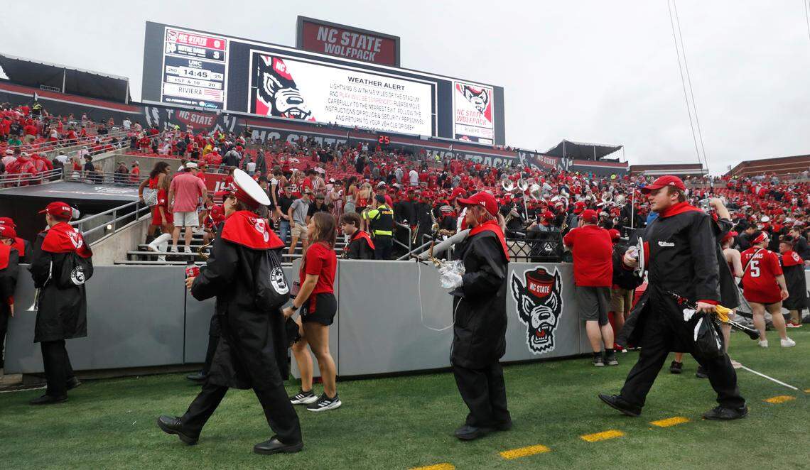 Members of the N.C. State marching band leave the stadium area after the game was postponed at the start of the second quarter due to weather in the area during the Wolfpack’s game against Notre Dame at Carter-Finley Stadium in Raleigh, N.C., Saturday, Sept. 9, 2023.