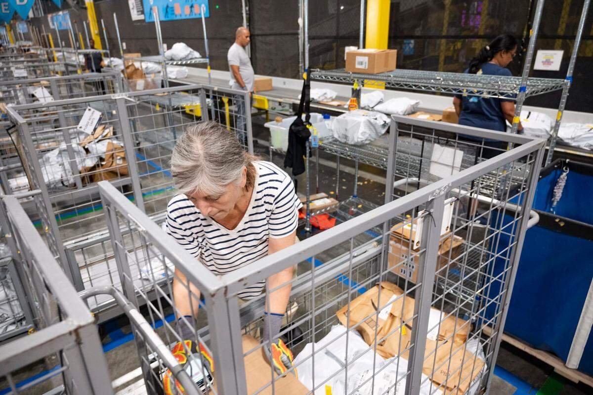 An Amazon worker sorts packages at the Same-Day Delivery Fulfillment Center in Durham on Wednesday July 10, 2024.