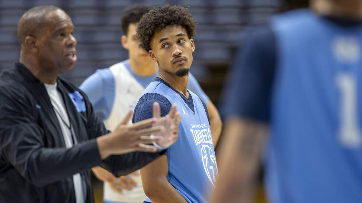 North Carolina senior guard Seth Trimble (7) listens to coach Hubert Davis during practice on Thursday, October 9. 2