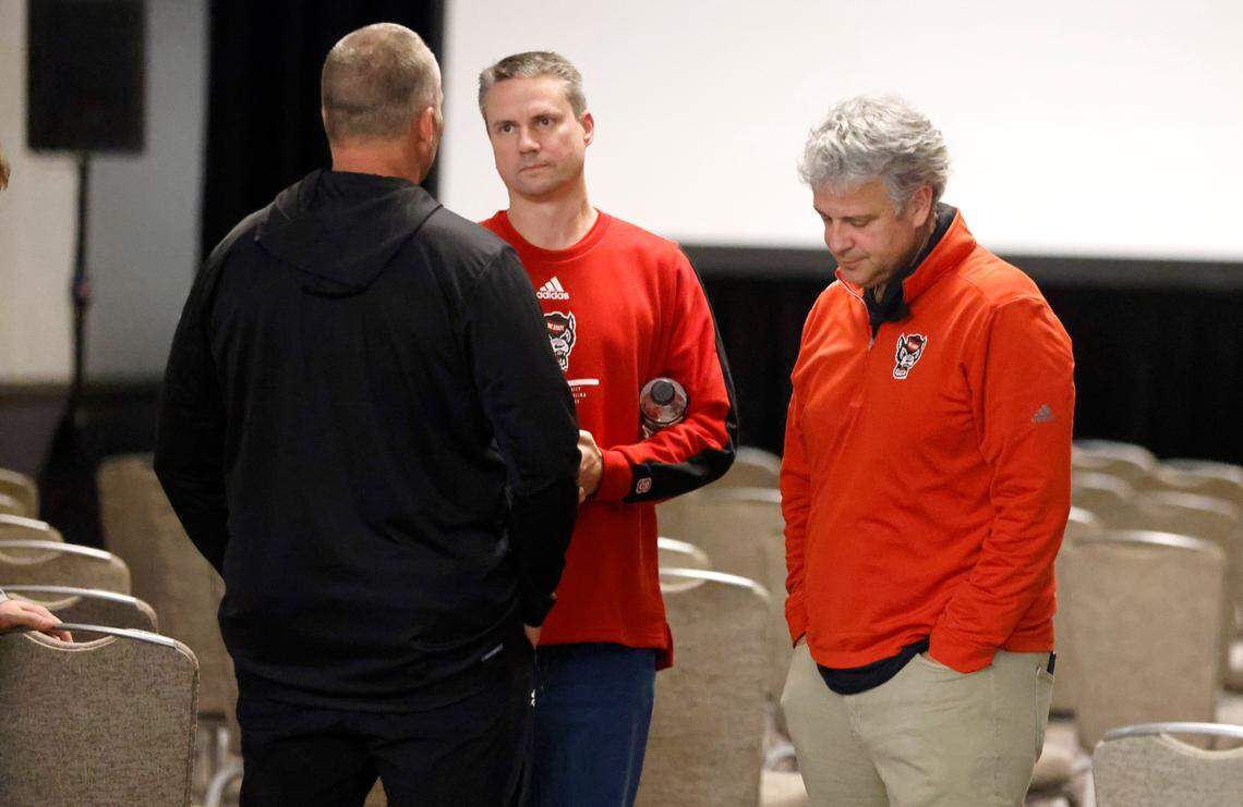 N.C. State head coach Dave Doeren talks with Fred Demarest, N.C. State senior AD for communications, left and athletics director Boo Corrigan in the team hotel after the Holiday Bowl was canceled just hours before kickoff in San Diego, CA Tuesday, Dec. 28, 2021.