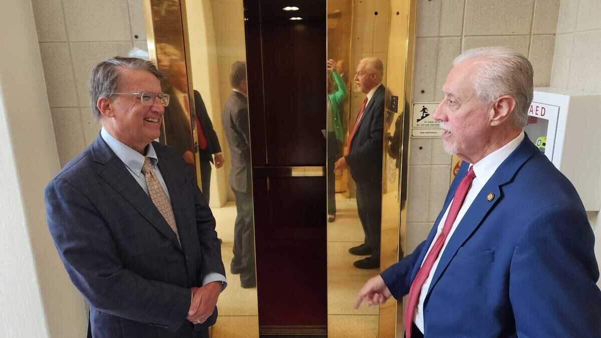 Former North Carolina Republican Gov. Pat McCrory, left, talks with N.C. Sen. Carl Ford, a Rowan County Republican, right, outside the elevator at the N.C. Legislative Building in Raleigh on June 4, 2025.