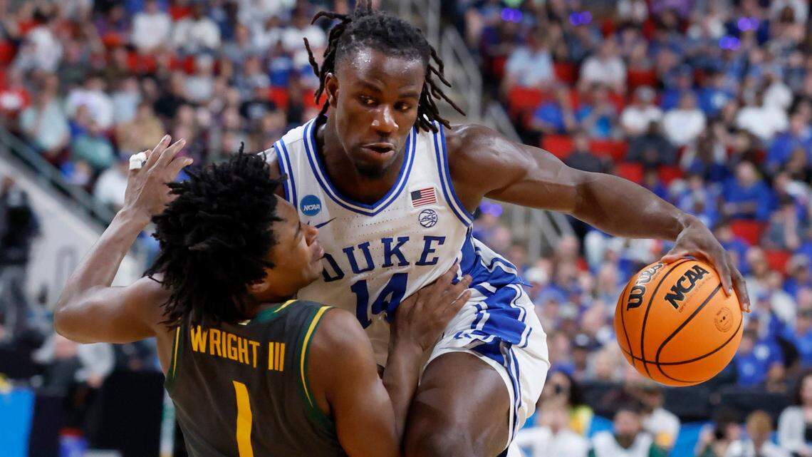 Baylor’s Robert Wright (1) fouls Duke’s Sion James (14) during the first half of Duke’s game against Baylor in the second round of the 2025 NCAA men’s basketball championship at the Lenovo Center in Raleigh, N.C., Sunday, March 23, 2025.