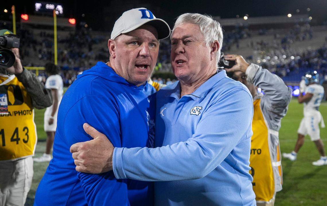 Duke coach Mike Elko embraces North Carolina coach Mack Brown following the Tar Heels’ 38-35 victory on Saturday, October 15, 2022 at Wallace-Wade Stadium in Durham, N.C.