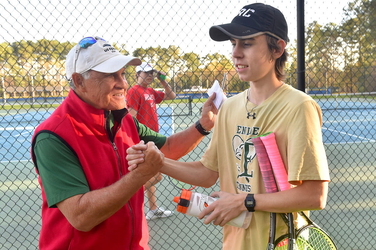 Enloe head coach Steve Spivey congratulates Noah Ross after his victory in doubles over Athens Drive. Enloe Tennis head Coach Steven Spivey gets his 1100th career victory with a win over Athens Drive High in Raleigh, N.C. on March 25, 2022.