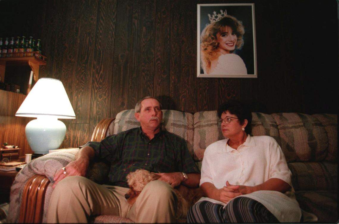 A 1995 photo shows Bill and Penny Vinson with a portrait of their daughter Beth Ellen Vinson, who was murdered after moving to Raleigh from her small town.