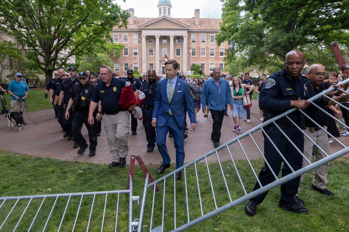 Then interim Chancellor Lee Roberts and police prepare to rehang an American flag after it was brought down by demonstrators and replaced with a Palestinian flag Tuesday, April 30, 2024 at UNC-Chapel Hill. About 1000 pro-Palestinian demonstrators rallied after a “Gaza solidarity encampment” was removed by police early Tuesday morning.