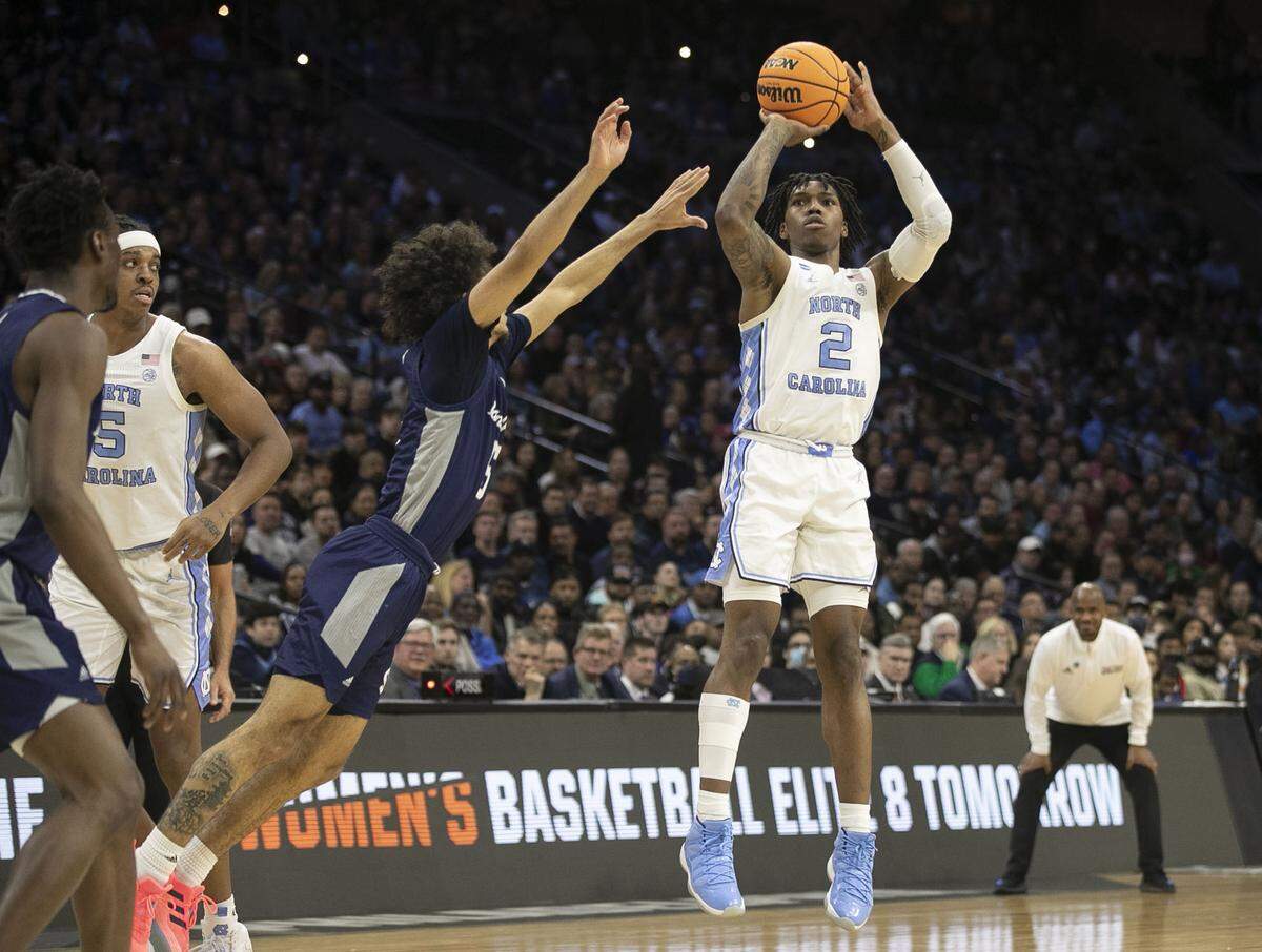 North Carolina’s Caleb Love (2) shoots over Saint Peter’s Daryl Banks III (5) during the second half in the NCAA East Regional final on Sunday, March 27, 2022 at Wells Fargo Center in Philadelphia, Pa.