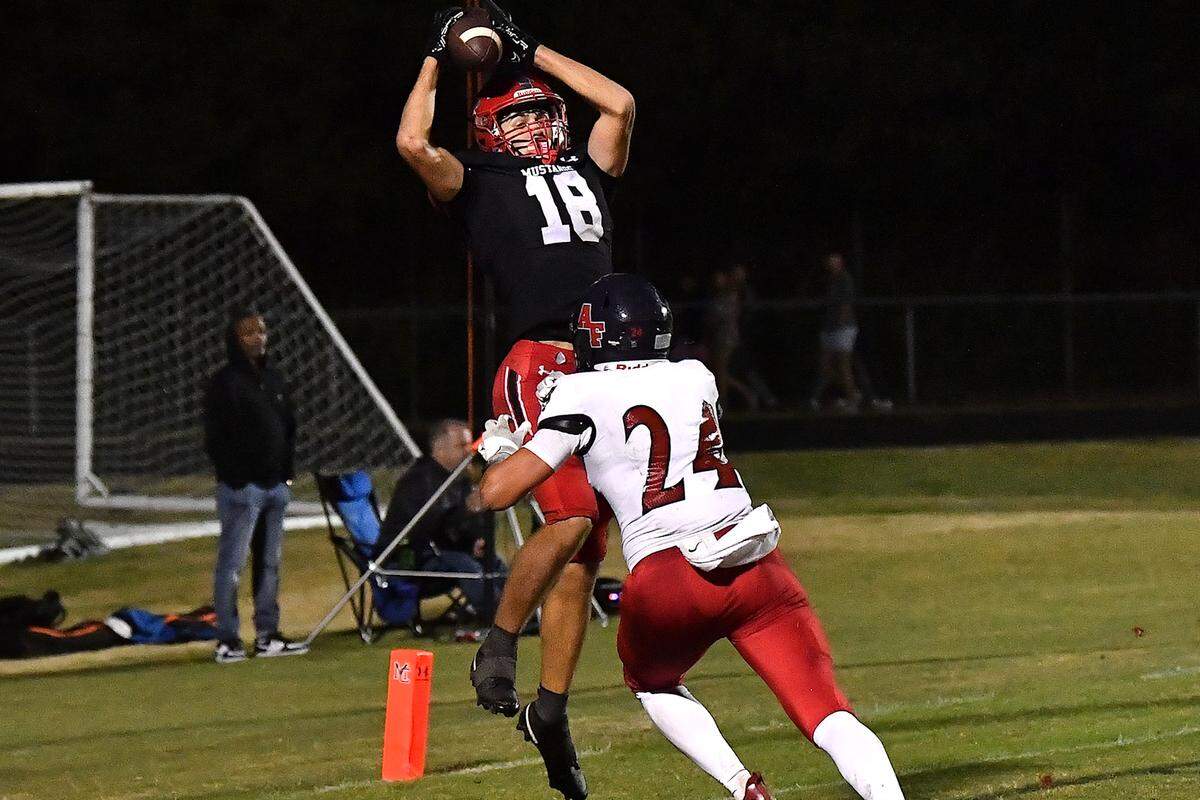Middle Creek wide receiver M.J. Bucci (18) makes the catch in the end zone for the touchdown against Apex Friendship’s Logan Faulring (24) late in the fourth quarter. The Middle Creek Mustangs and the Apex Friendship Patriots met in a football game in Cary, N.C. on October 25, 2024.