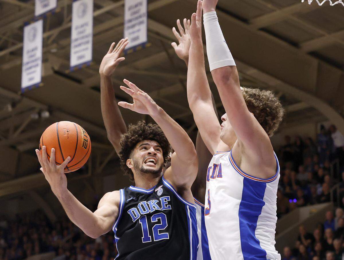 Duke’s Cameron Boozer drives to the basket against Florida's Micah Handlogten during the first half of the Blue Devils’ game in the ACC/SEC Challenge on Tuesday, Dec. 2, 2025 at Cameron Indoor Stadium in Durham, N.C.