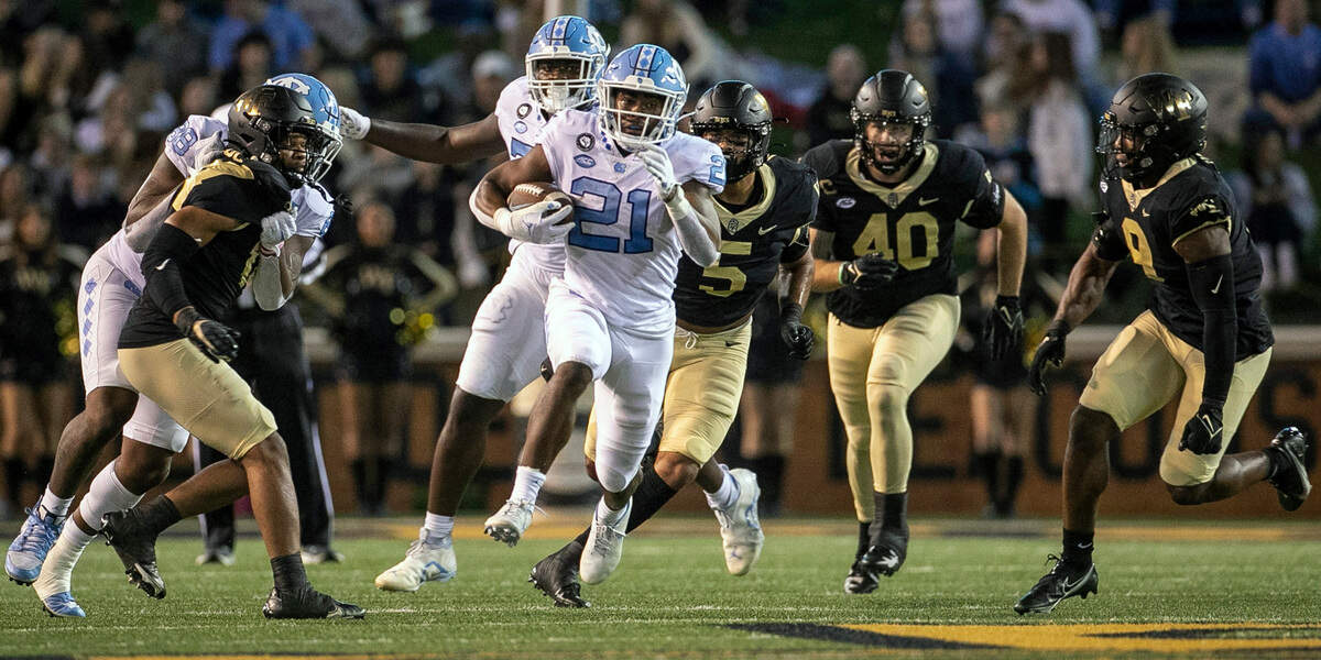 North Carolina’s Elijah Green (21) looks for running room in the first quarter against Wake Forest on Saturday, November 12, 2022 at Truist Field in Winston-Salem, N.C.