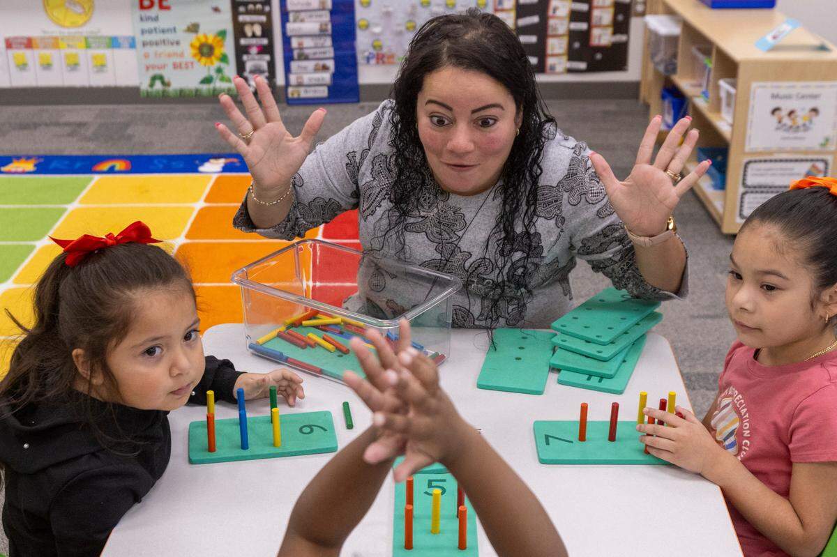 Xiomara De Jesus-Candelaria leads a group of pre-schoolers in a counting lesson at the Early Learning Center at Memory Road, Thursday, Nov. 30, 2023. The Center is Wake County’s first standalone Pre-K center with space for up to 132 students.
