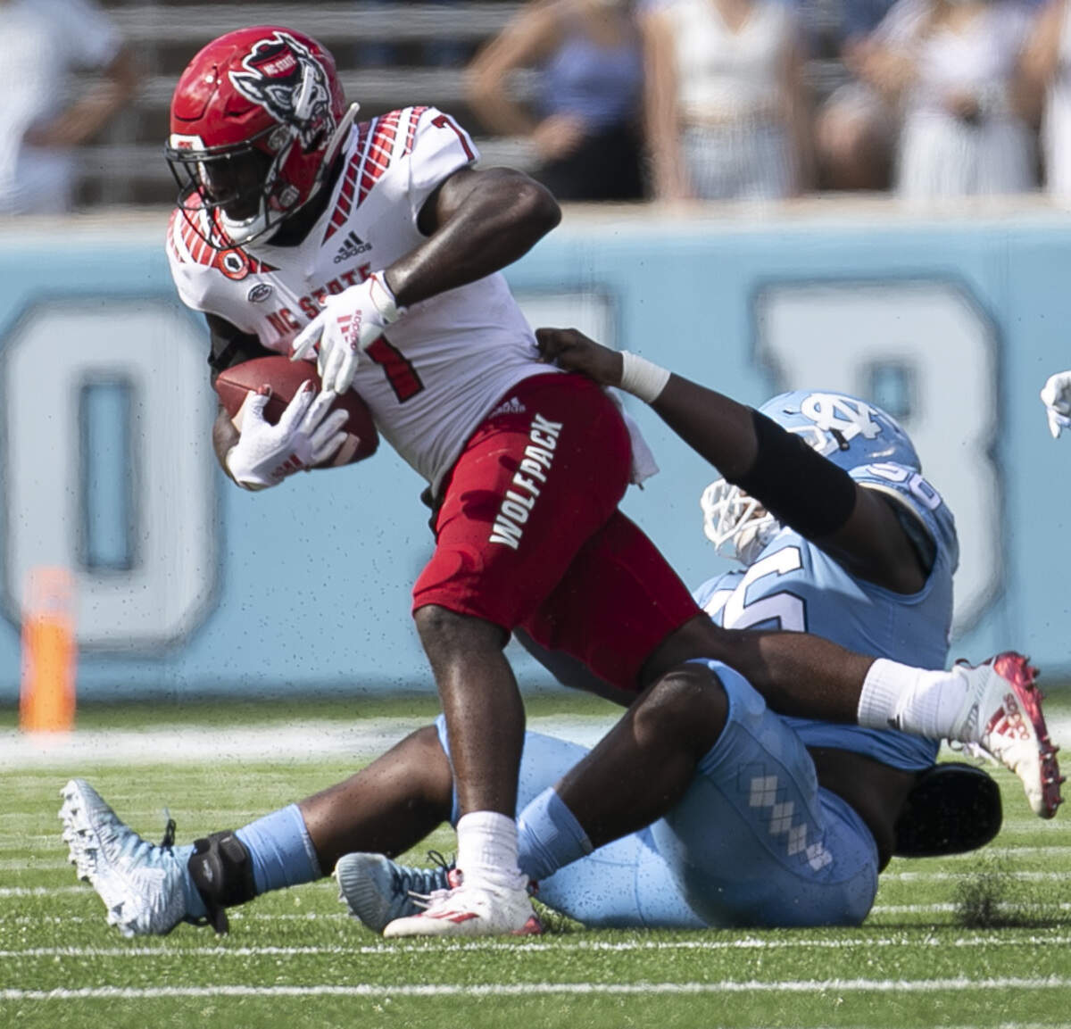 North Carolina’s Tomari Fox (56) stops N.C. State’s Zonovan Knight (7) for a los in the first quarter at Kenan Stadium on Saturday, October 24, 2020 in Chapel Hill, N.C.