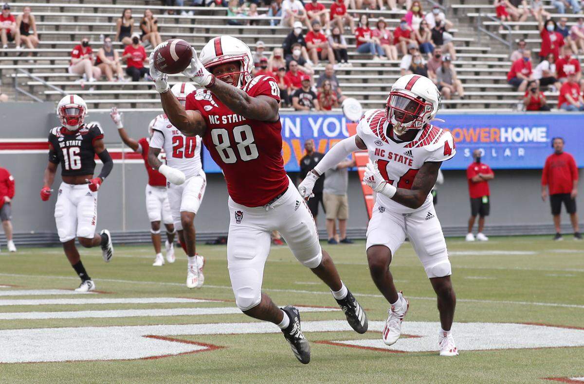N.C. State wide receiver Devin Carter (88) pulls in a touchdown as Mario Love, Jr. (44) defends during the first half of N.C. State football’s spring game at Carter-Finley Stadium in Raleigh, N.C., Saturday, April 10, 2021.
