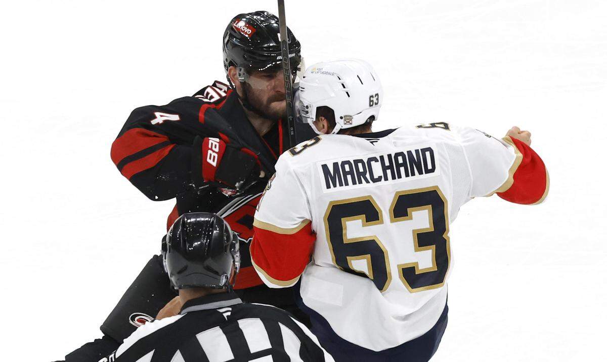 Carolina’s Shayne Gostisbehere (4) tangles with the PanthersÕ Brad Marchand (63) during the third period of the Florida PanthersÕ 5-2 victory over the Carolina Hurricanes in Game 1 of the Eastern Conference Finals at the Lenovo Center in Raleigh, N.C., Tuesday, May 20, 2025.