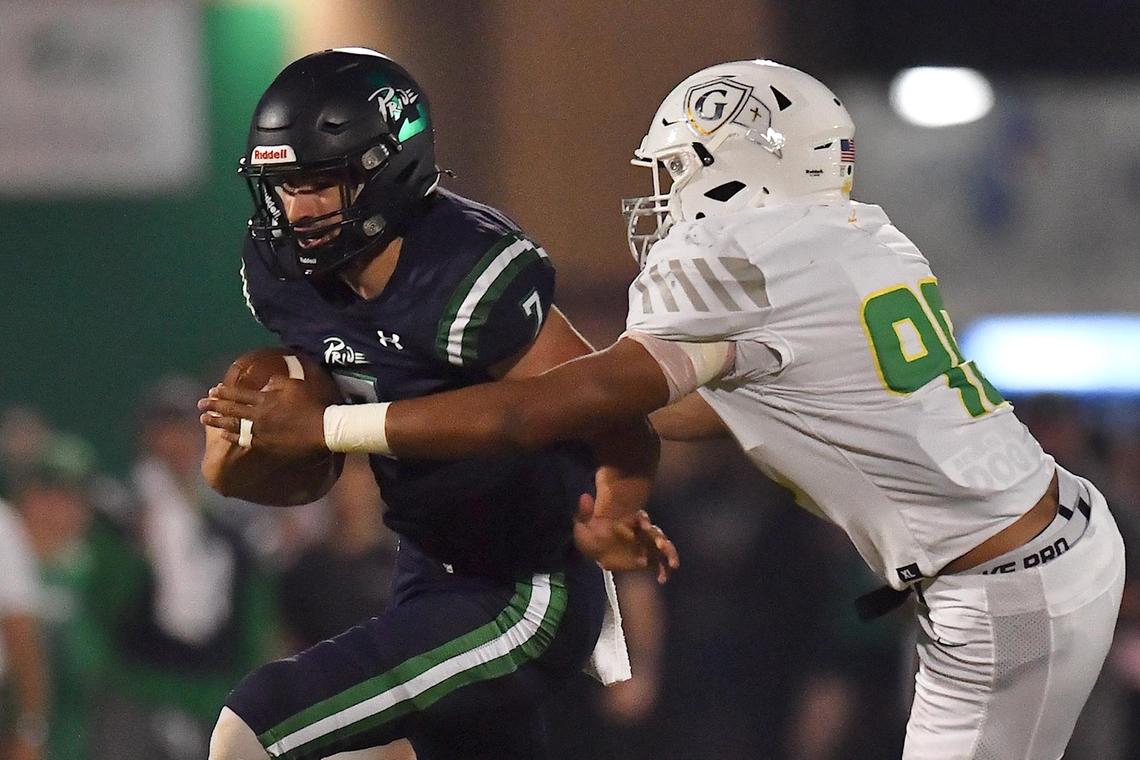 Cardinal Gibbons’ Joshua Stoneking (99) grapples Leesville quarterback John Mark Shaw (7) during the first half. The Leesville Road Pride and the Cardinal Gibbons Crusaders met in a football game in Raleigh, N.C. on October 7, 2022.