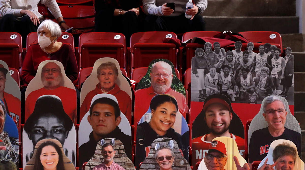 Fans watch during the first half of N.C. State’s game against Virginia Tech at Reynolds Coliseum in Raleigh, N.C., Sunday, January 24, 2021.