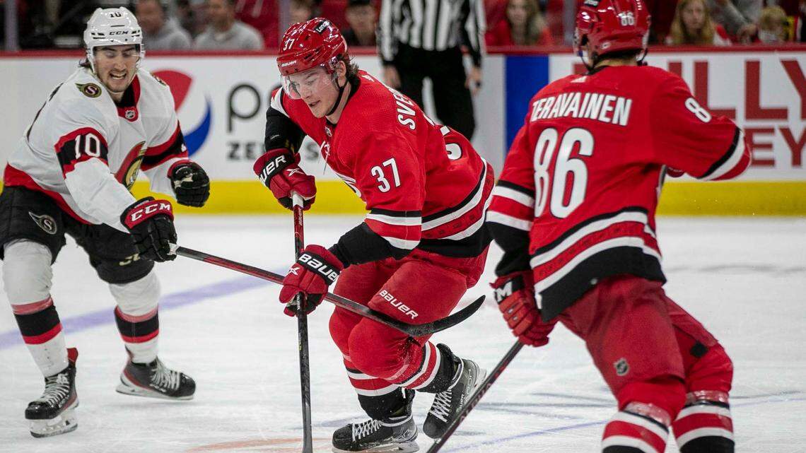 Carolina Hurricanes’ Andrei Svechnikov (37) and Teuvo Teravainen (86) control the puck against Ottawa’s Alex Formenton (10) on Thursday, December 2, 2021 at PNC Arena in Raleigh, N.C.