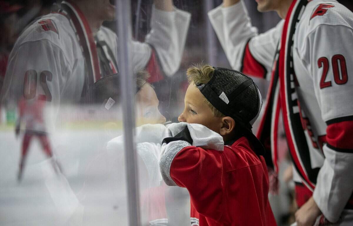 Eight-year-old Bryson Denning of Benson, N.C., leans against the glass during the fourth overtime period of the Carolina Hurricanes’ Eastern Conference Finals game agains the Florida Panthers, early on on Friday morning, May 19, 2023 at PNC Arena in Raleigh, N.C.