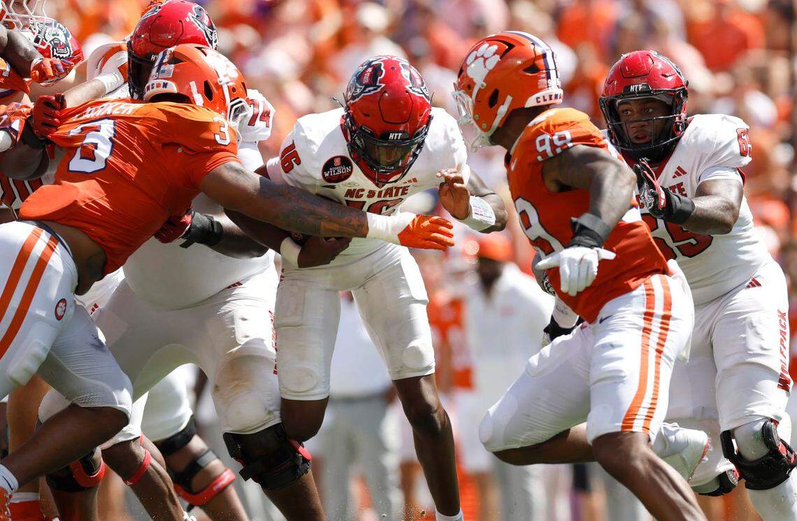 N.C. State quarterback CJ Bailey (16) is sacked by the Clemson defense during the first half of N.C. State’s game against Clemson at Memorial Stadium in Clemson, S.C., Saturday, Sept. 21, 2024.