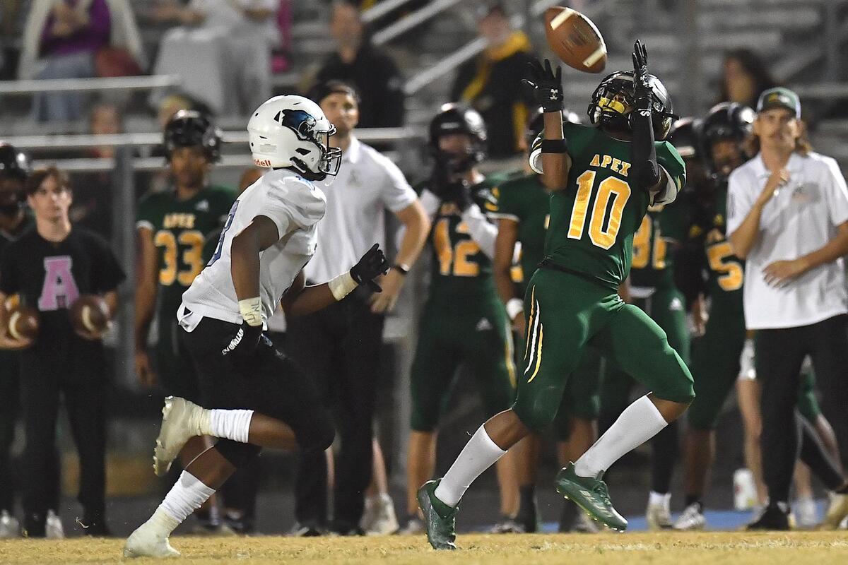 Apex wide receiver Brandon Tate (10) makes the pass reception ahead of Panther Creek’s Marion Turner (8) during the second half. The Apex Cougars and the Panther Creek Catamounts met in a NCHSAA 4A 1st round football playoff game in Apex, NC on November 4, 2022.