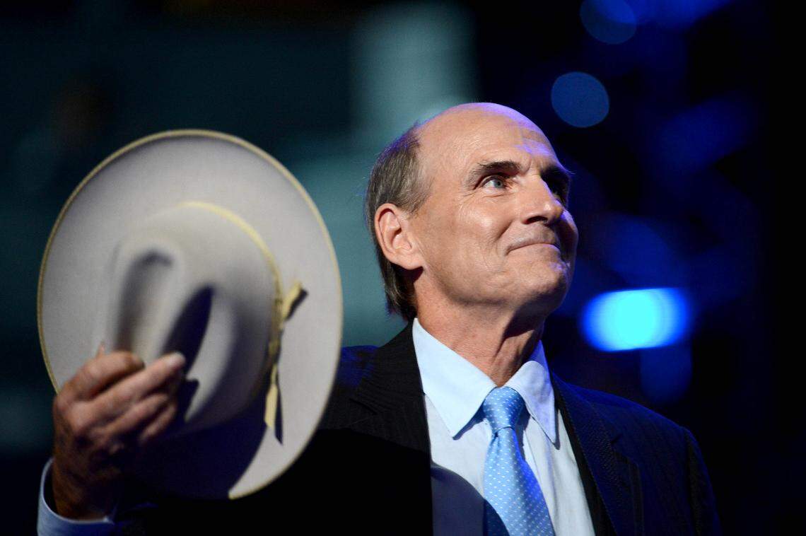 Singer James Taylor tips his hat to the crowd while performing on stage for the final session of the Democratic National Convention in Charlotte, NC Friday, Sept. 6, 2012.