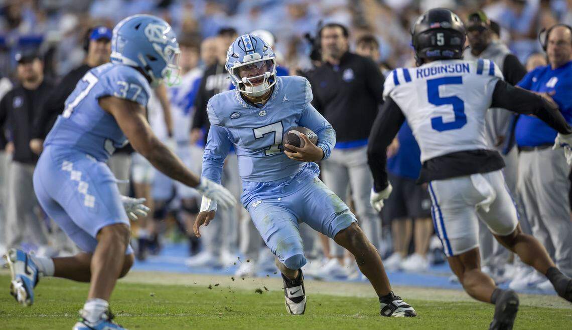 North Carolina quarterback Gio Lopez (7) looks for running room on a 21-yard gain against Duke in the second quarter on Saturday, November 22, 2025 at Kenan Stadium in Chapel Hill, N.C.