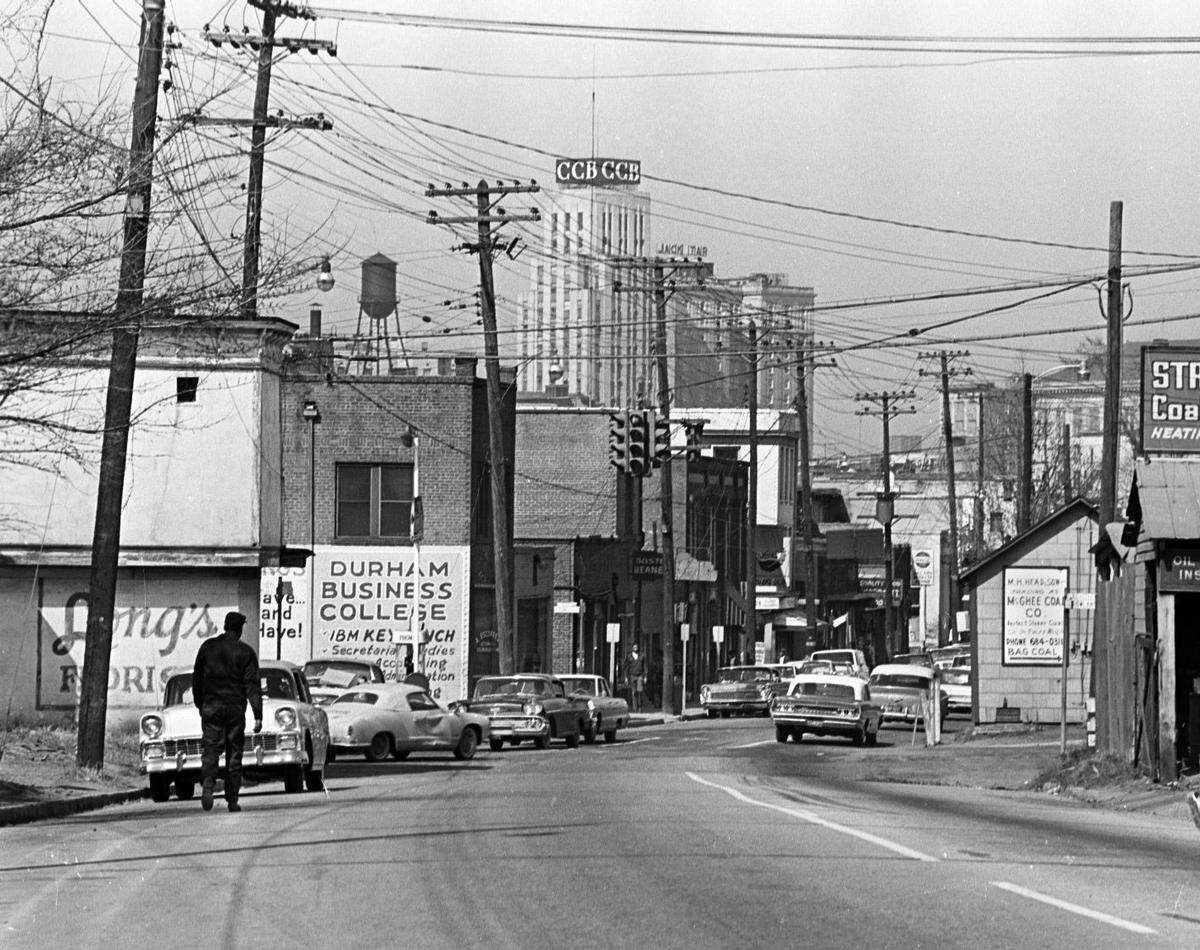 A photo from 1965 shows Pettigrew Street, west of Dillard Street, part of Durham’s Hayti business district before many of the homes and businesses were torn down in as part of urban renewal.