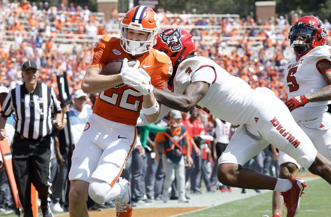 Clemson wide receiver Cole Turner (22) completes an 18-yard touchdown run as N.C. State cornerback Aydan White (3) defends during the first half of N.C. State’s game against Clemson at Memorial Stadium in Clemson, S.C., Saturday, Sept. 21, 2024.