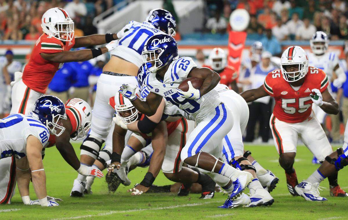 Duke Blue Devils running back Deon Jackson (25) runs passed defenders in the opening play of the game to score for Duke as the University of Miami hosts Duke University at Hard Rock Stadium in Miami Gardens on Saturday, Nov. 3, 2018.