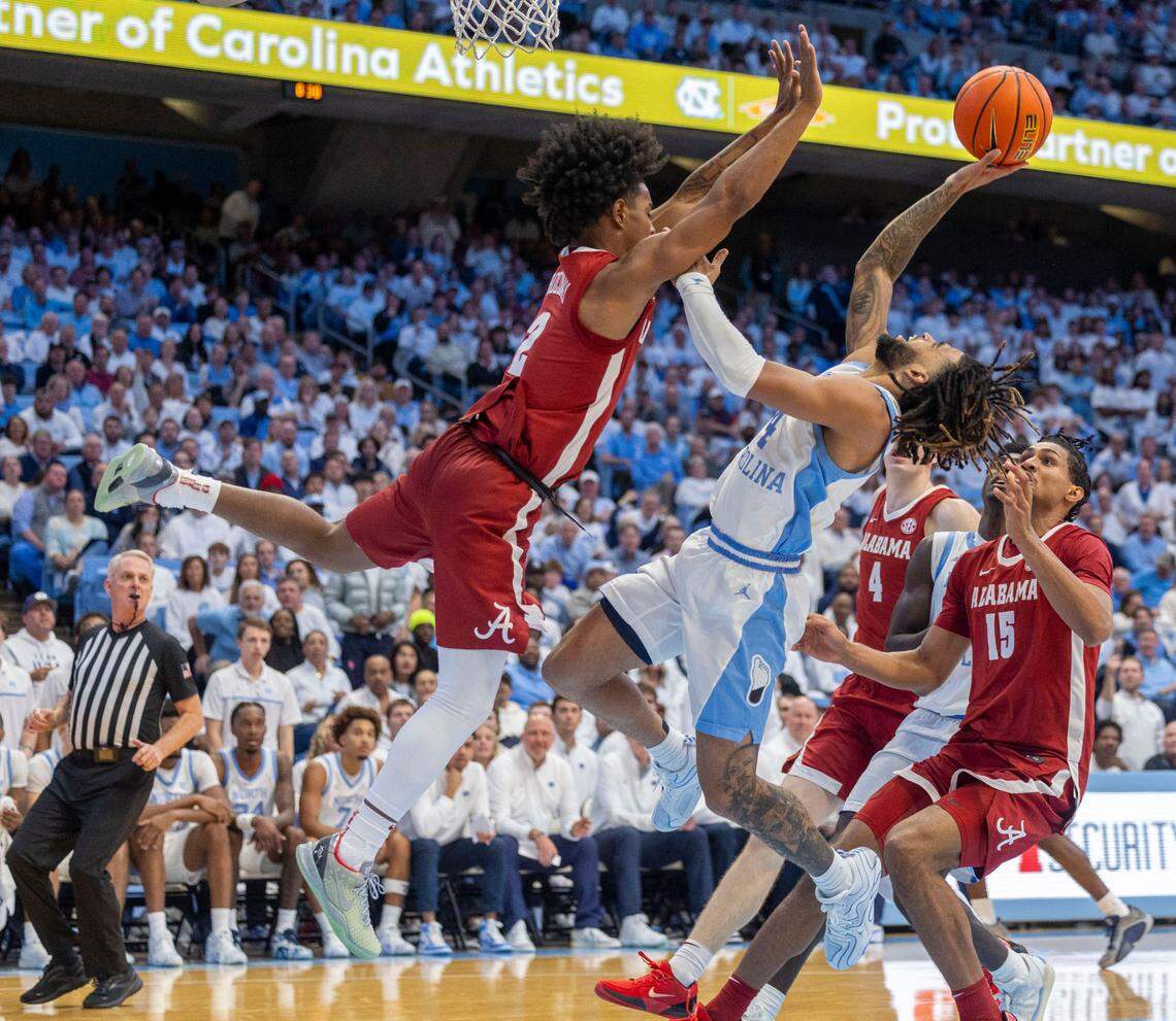 Alabama guard Aden Holloway (2) defends North Carolina guard R.J. Davis (4) in the second half on Wednesday, December 4, 2024 at the Smith Center in Chapel Hill, N.C.