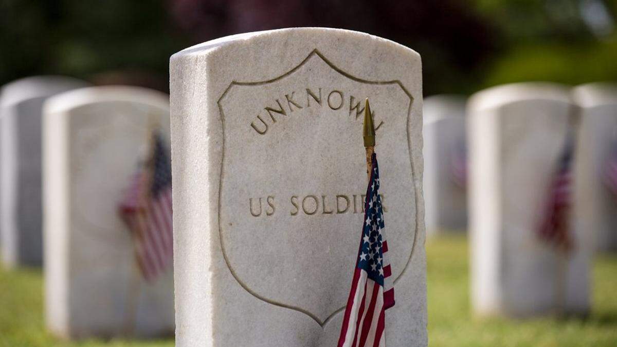 The gravestone of unknown solider in the Raleigh National Cemetery is decorated with a flag for Memorial Day on May 28, 2021, in Raleigh.