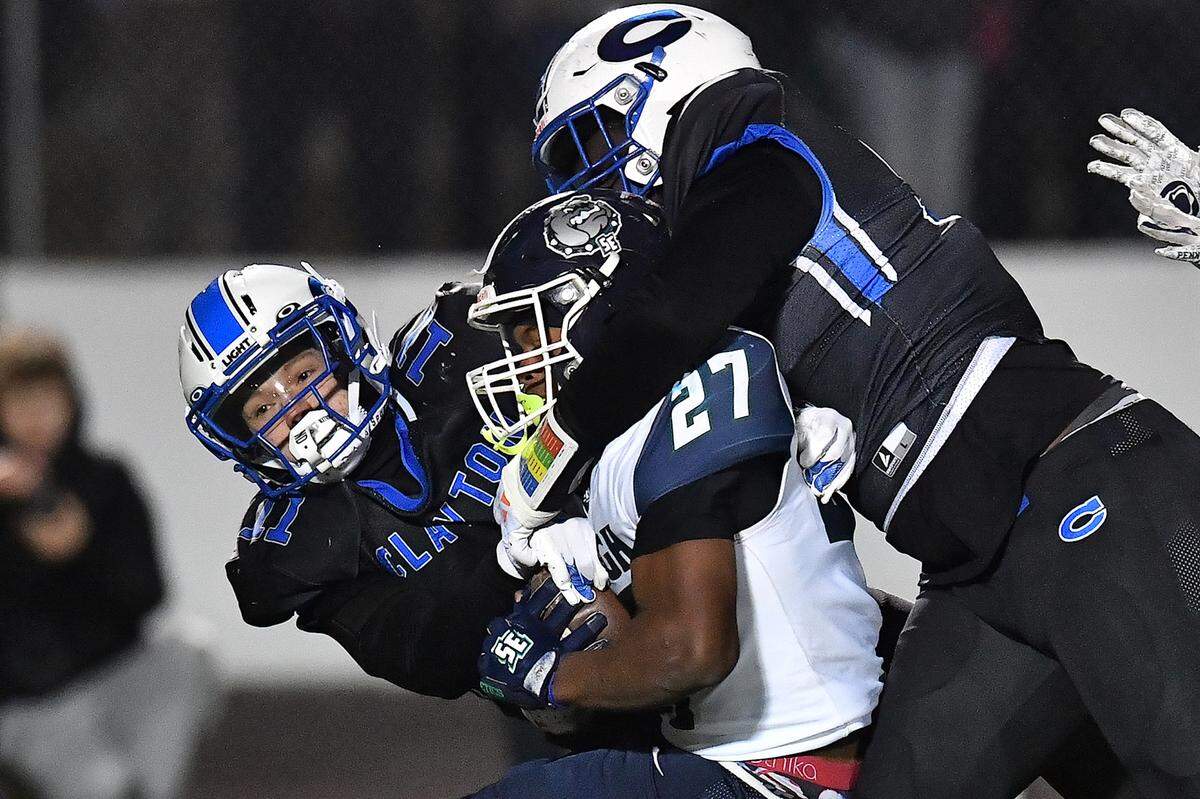 Southeast Raleigh running back James Adams IV (27) is tackled by the Clayton defense during the second half. The Clayton Comets and the Southeast Raleigh Bulldogs met in the fourth round of the NCHSAA 7A Playoffs in Clayton, N.C. on November 28, 2025.