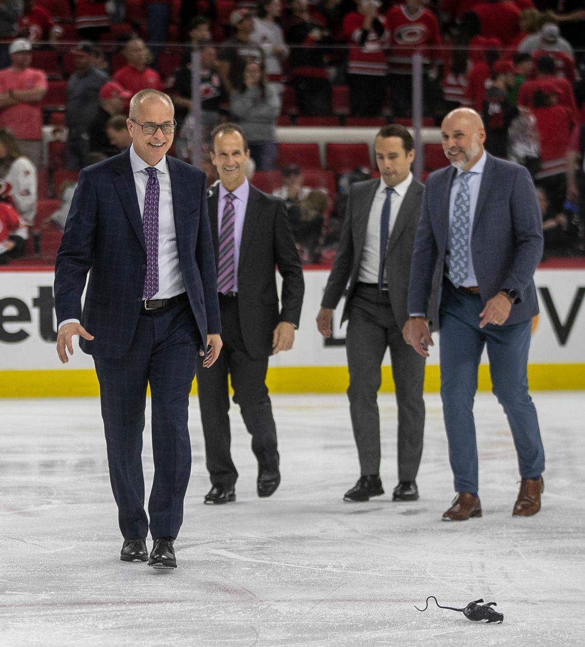Florida Panthers coach Paul Maurice smiles as he notices a rat on the ice, as he and the coaching staff leave the ice following the Panthers 2-1 overtime victory against the Carolina Hurricanes in Game 2 of the Eastern Conference Finals on Saturday, May 20, 2023 at PNC Arena in Raleigh, N.C.