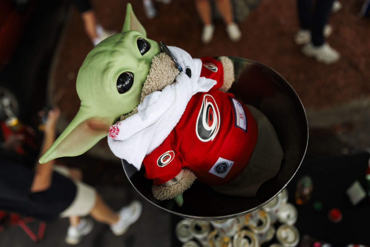 A baby Yoda doll dressed in Carolina Hurricanes merchandise sits atop the CaneEvel’s mock Stanley Cup—constructed with Coors Light beer cans— outside the Lenovo Center on June 11, 2026, in Raleigh, North Carolina. The Carolina Hurricanes take on the Vegas Golden Knights for Game 5 of the Stanley Cup Final.