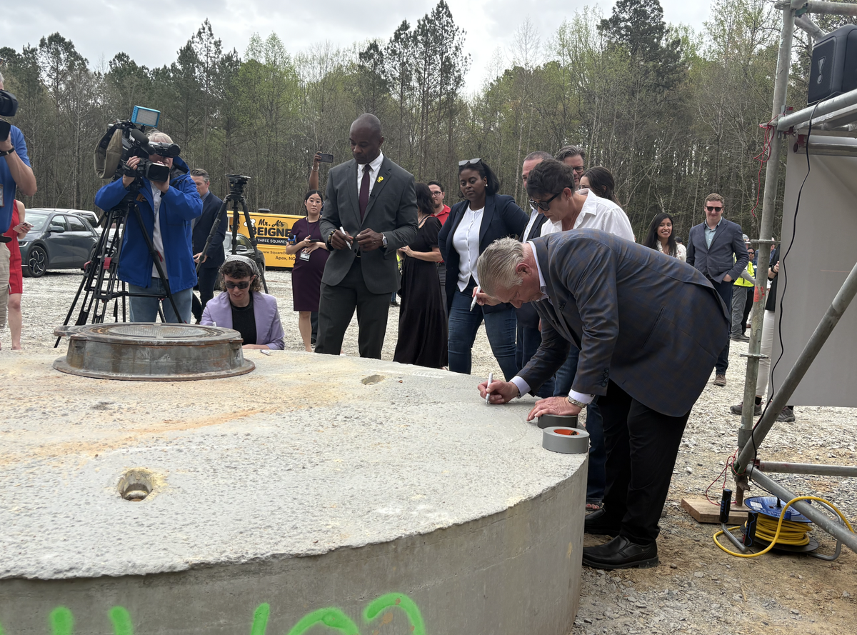 “Go baby go!” crooned RXR’s executive vice president Joseph Graziose, as he hunched over in his fitted blue suit, signing the manhole.