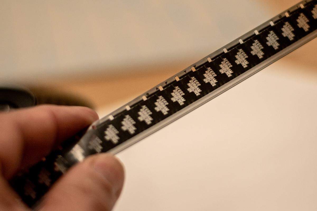 Tom Whiteside (not pictured) scrolls through the negative frames of the title sequence from the 1948 film “Negro Durham Marches On” at the Durham County Library main branch on July 28, 2021.