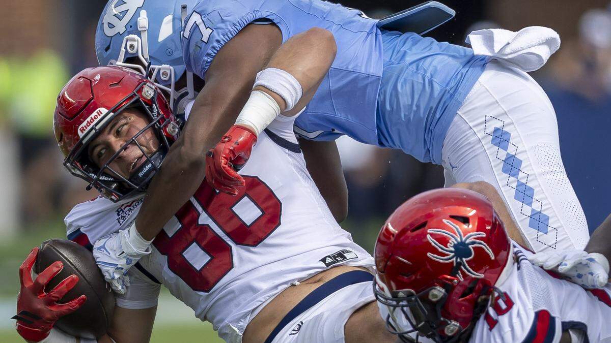 North Carolina linebacker Khmori House (7) stops Richmond tight end Aidan Steinfeldt (86) after a three-yard gain during the first quarter on Saturday, September 13, 2025 at Kenan Stadium in Chapel Hill, N.C.