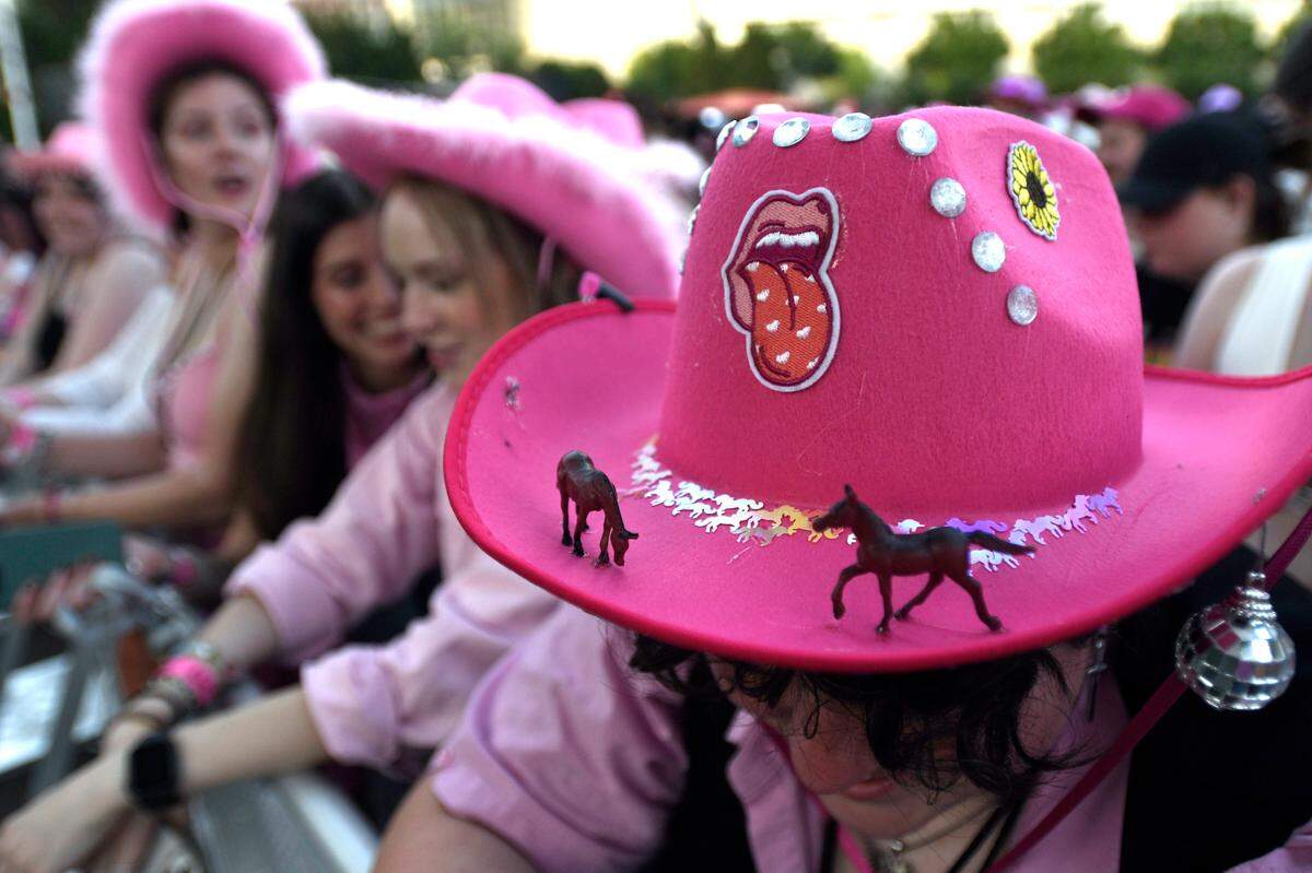 Fans display their pink cowboy hats, a signature of musician Chappell Roan, and crowd the barricade for Roan’s show at Red Hat Amphitheater, Wednesday night, June 12, 2024.