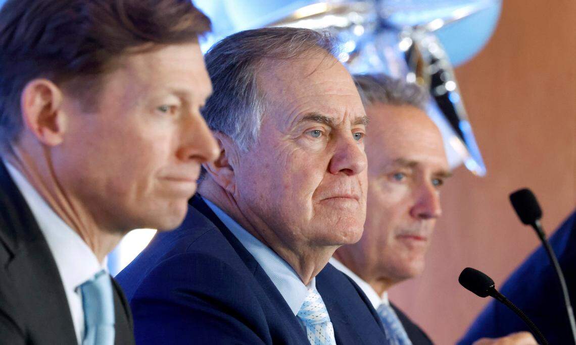 New North Carolina head football coach Bill Belichick listens to a question during a press conference announcing his hiring at the Loudermilk Center for Excellence at UNC in Chapel Hill, N.C., Thursday, Dec. 12, 2024. UNC Chancellor Lee Roberts sits to the left and AD Bubba Cunningham sits to the right.