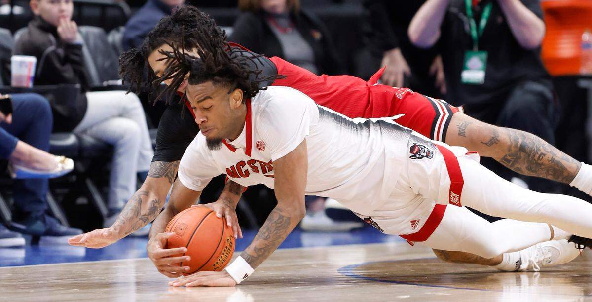 N.C. State’s Jayden Taylor (1) steals the ball from Louisville’s Skyy Clark (55) during the second half of N.C. State’s 94-85 victory over Louisville in the first round of the 2024 ACC Men’s Basketball Tournament at Capital One Arena in Washington, D.C., Tuesday, March 12, 2024.