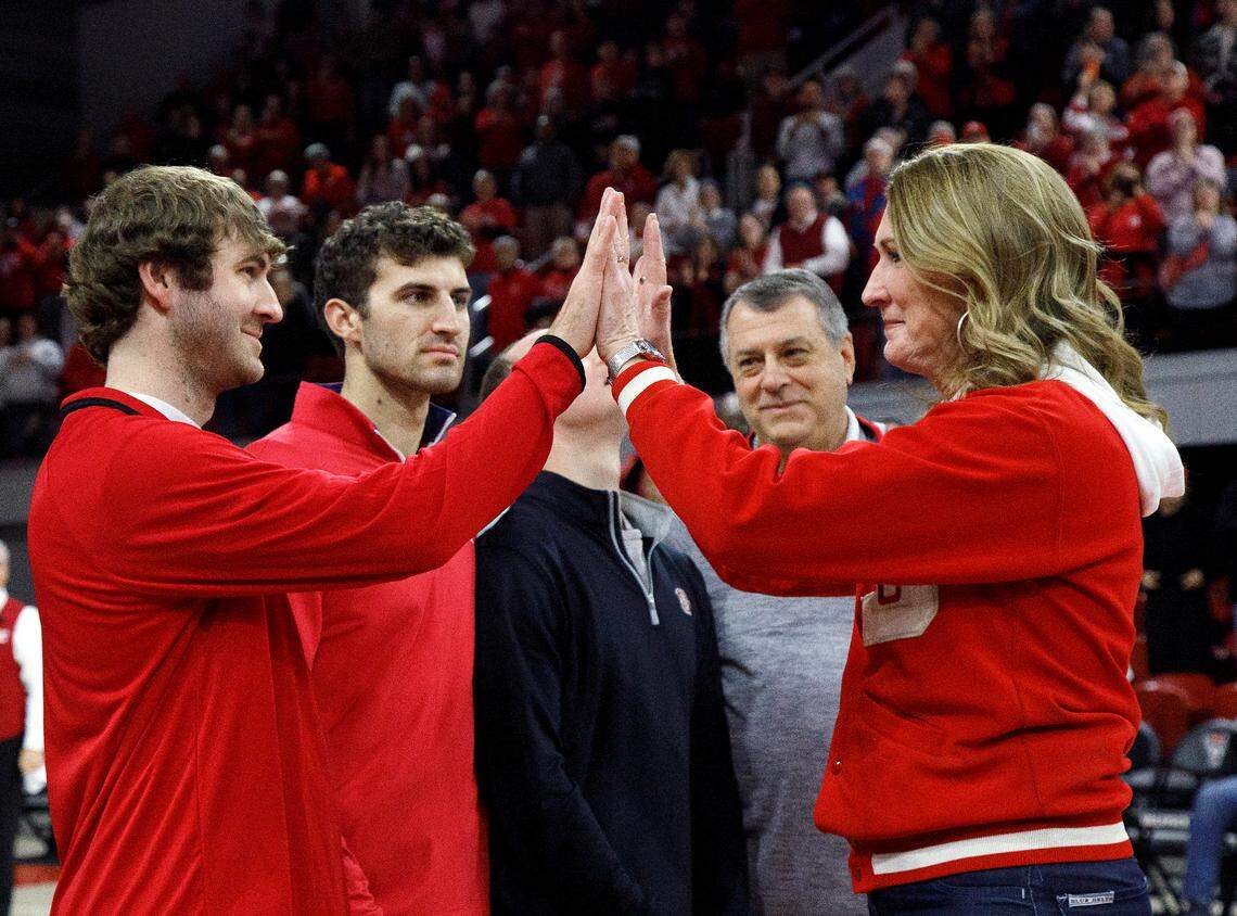 Debbie Antonelli, broadcaster and former N.C. State women’s basketball player, high fives her son, Joe Antonelli, as she is honored during a halftime ceremony of the Wolfpack’s game against Pittsburgh on Thursday, Jan. 16, 2025, at Reynolds Coliseum in Raleigh, N.C. The Wolfpack added Antonelli to its women’s basketball Ring of Honor for her playing career, broadcast career and philanthropic contributions to the program.
